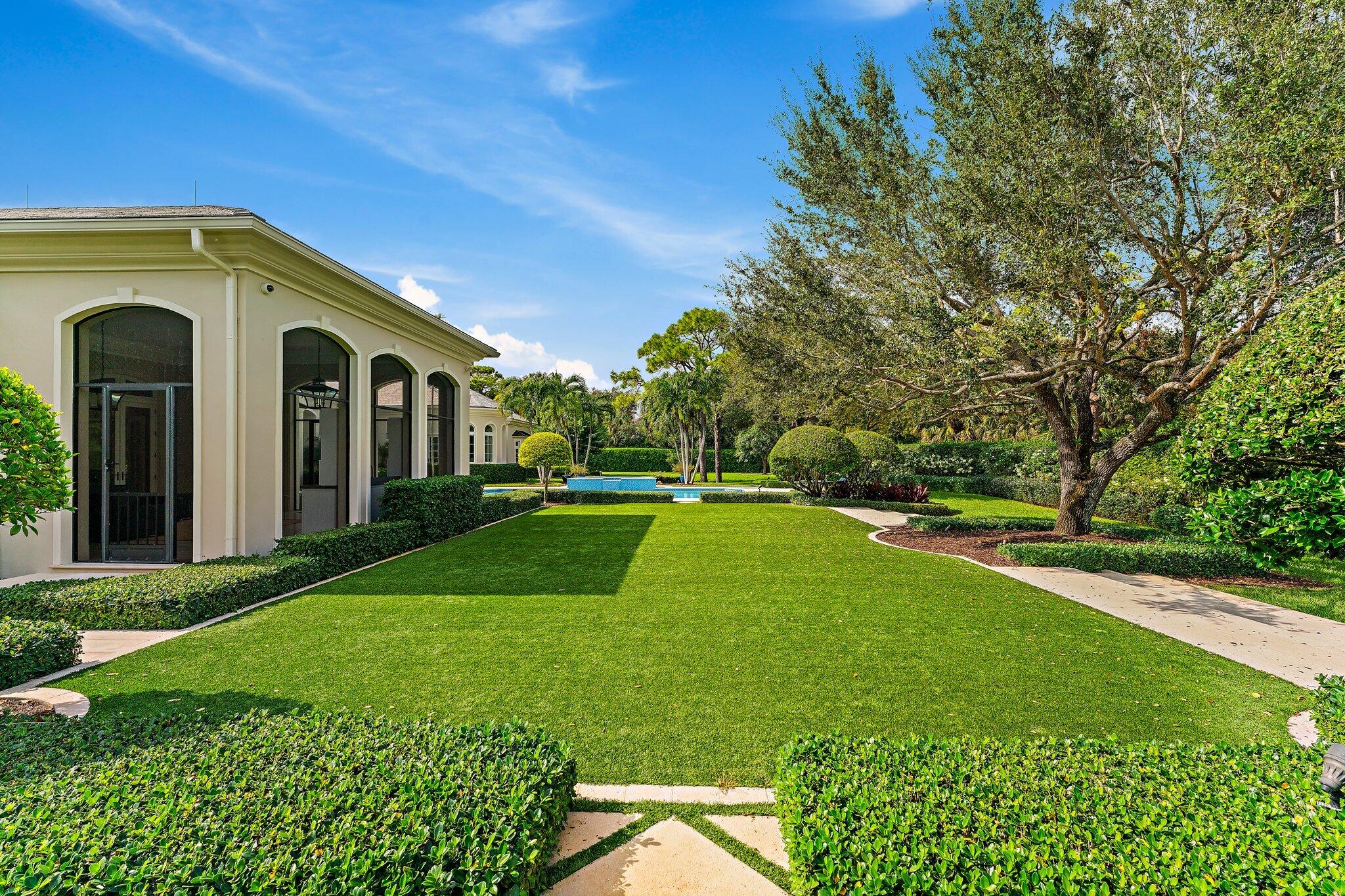 124 Bears Club Drive Jupiter, FL 33477 - Photo 16 of 22 a view of a house with a backyard