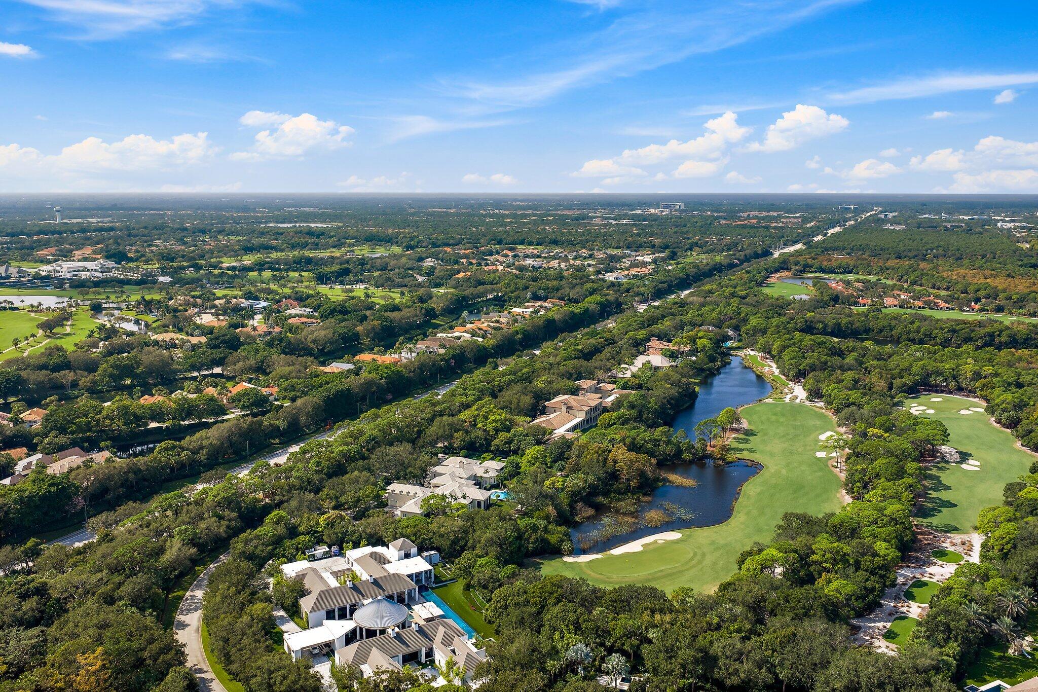 124 Bears Club Drive Jupiter, FL 33477 - Photo 2 of 22 an aerial view of residential houses with outdoor space and trees