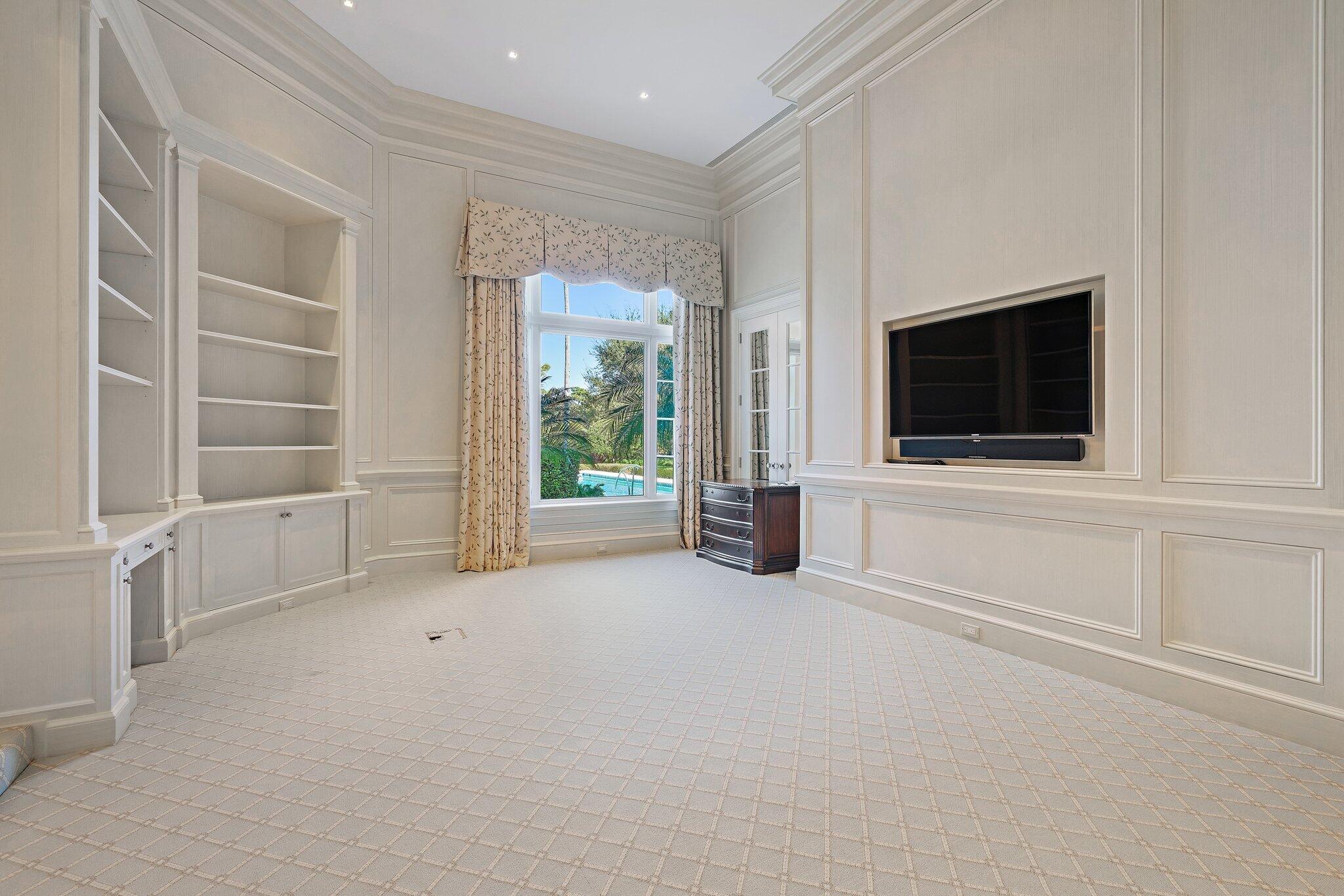 124 Bears Club Drive Jupiter, FL 33477 - Photo 28 of 75 a view of an empty room with a flat screen tv and a window