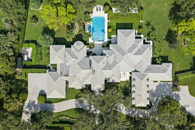 an aerial view of residential house with outdoor space and parking