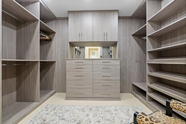 a spacious bedroom with a bed and a couch