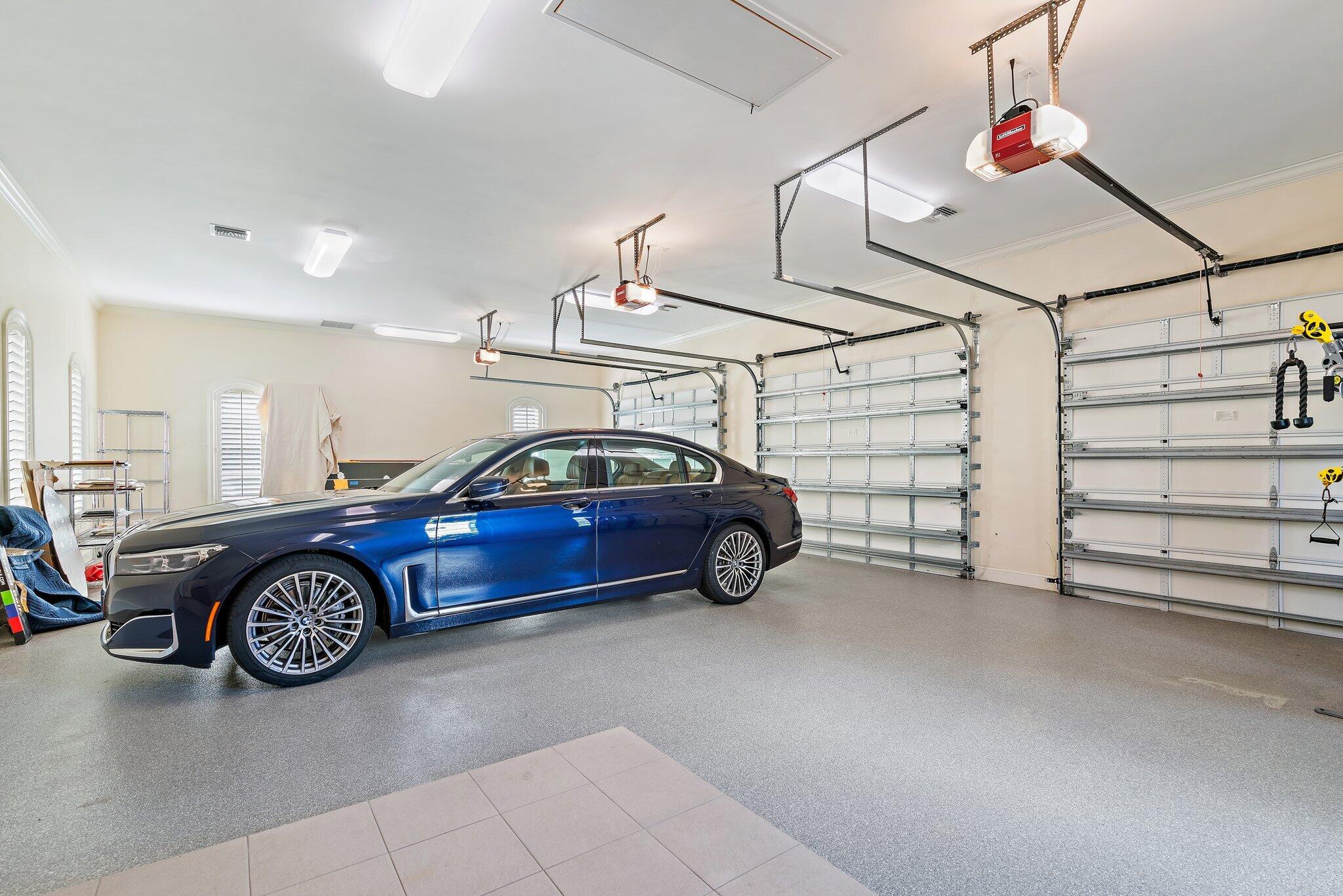 124 Bears Club Drive Jupiter, FL 33477 - Photo 38 of 75 a view of a garage and car parked