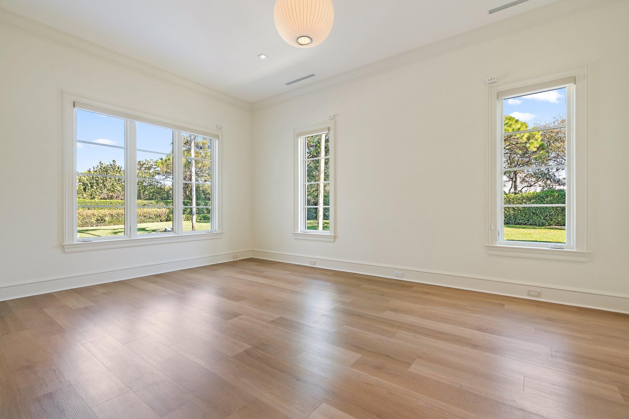 124 Bears Club Drive Jupiter, FL 33477 - Photo 56 of 75 a view of an empty room with wooden floor and a window