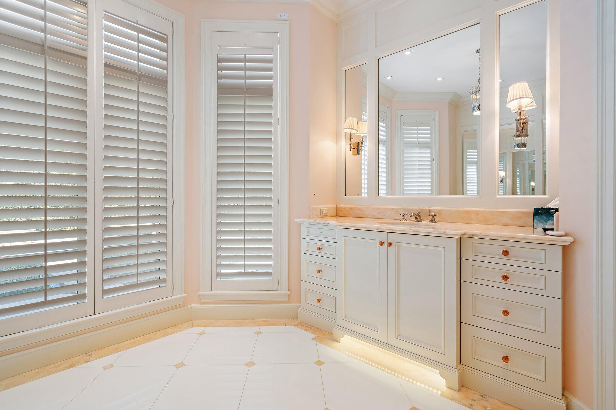 124 Bears Club Drive Jupiter, FL 33477 - Photo 59 of 75 a bathroom with a sink vanity and a mirror