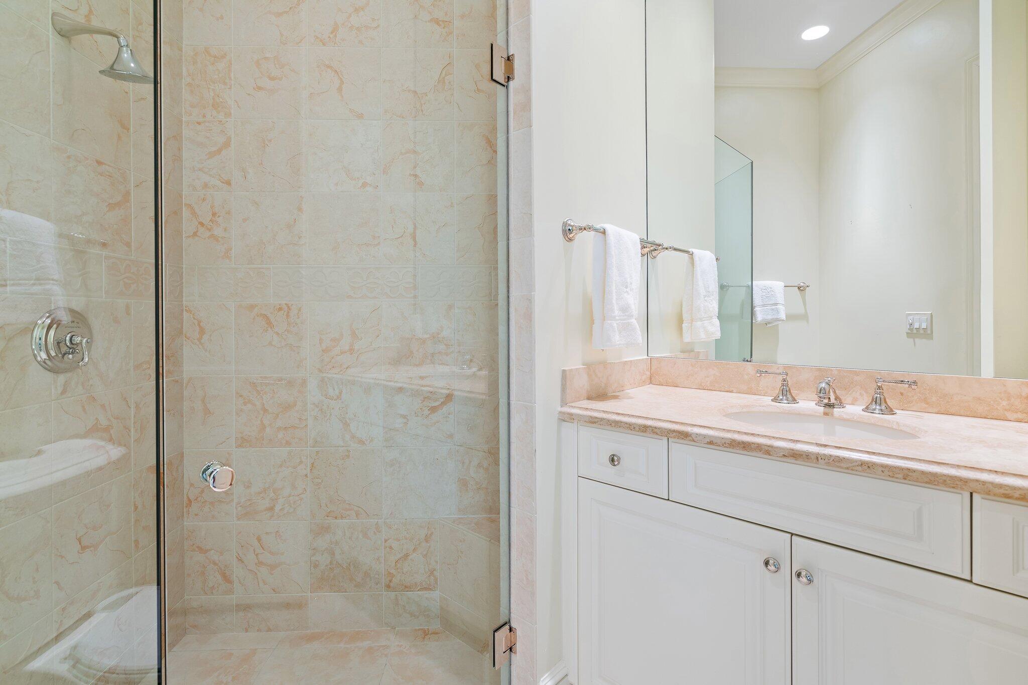 124 Bears Club Drive Jupiter, FL 33477 - Photo 64 of 75 a bathroom with a sink and a mirror