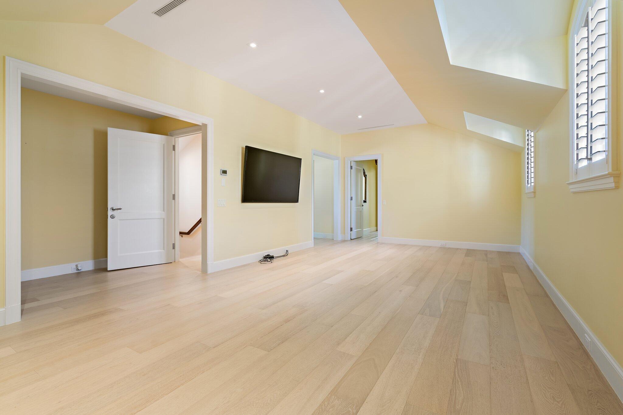 124 Bears Club Drive Jupiter, FL 33477 - Photo 70 of 75 a view of an empty room with wooden floor and a window