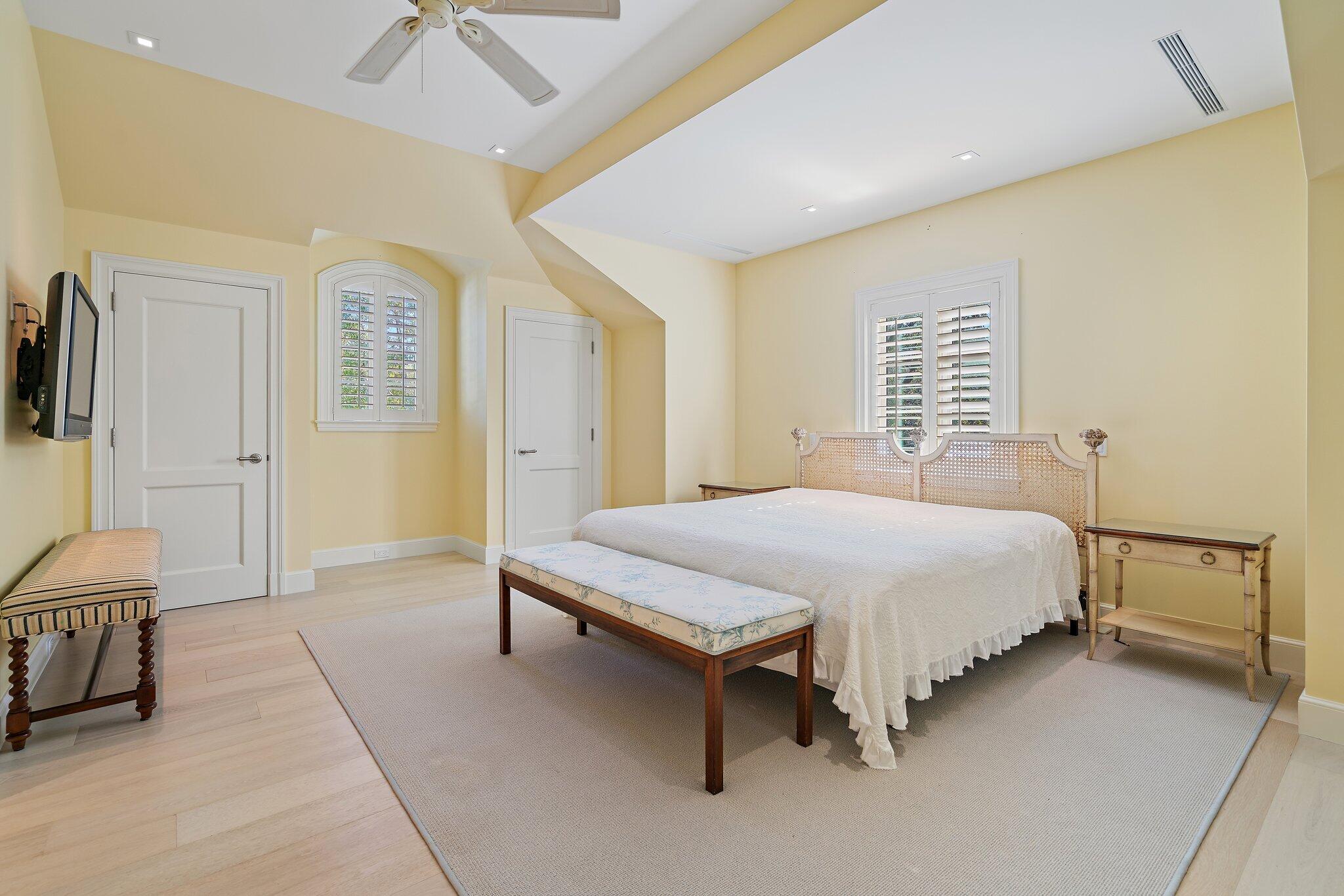 124 Bears Club Drive Jupiter, FL 33477 - Photo 75 of 75 a spacious bedroom with a bed and a couch