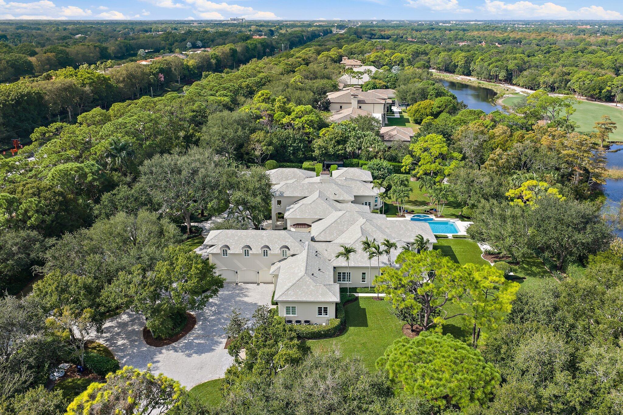 124 Bears Club Drive Jupiter, FL 33477 - Photo 8 of 22 an aerial view of a house with a yard