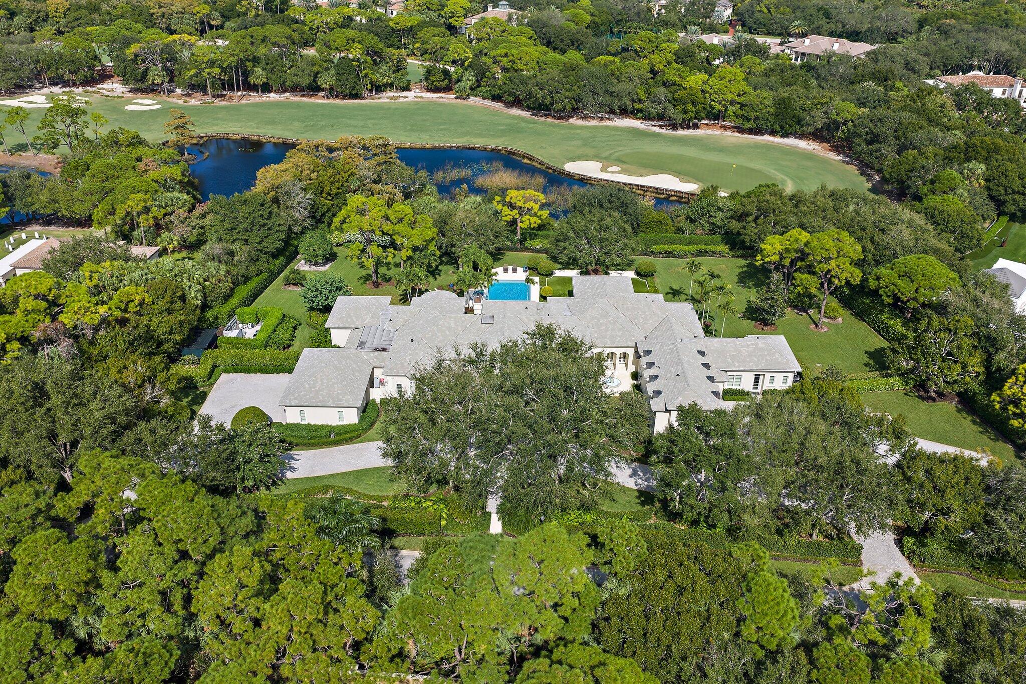 124 Bears Club Drive Jupiter, FL 33477 - Photo 9 of 22 an aerial view of residential houses with outdoor space and trees all around