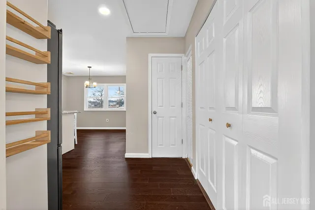 a view of a hallway with wooden floor windows