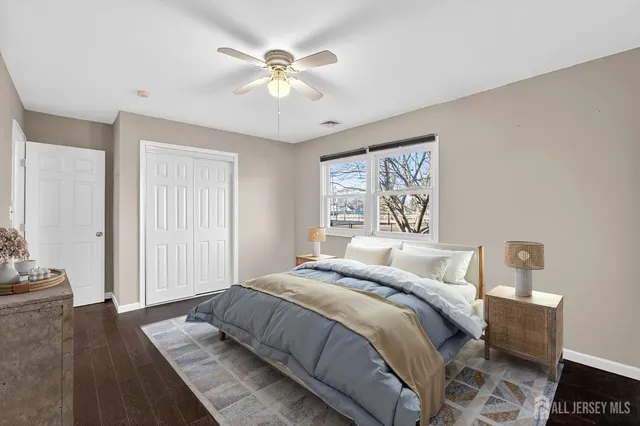 a bedroom with a large bed and a chandelier