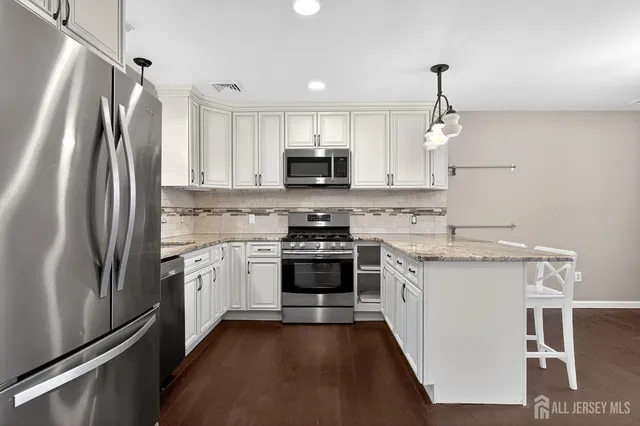 a kitchen with a stove and a refrigerator