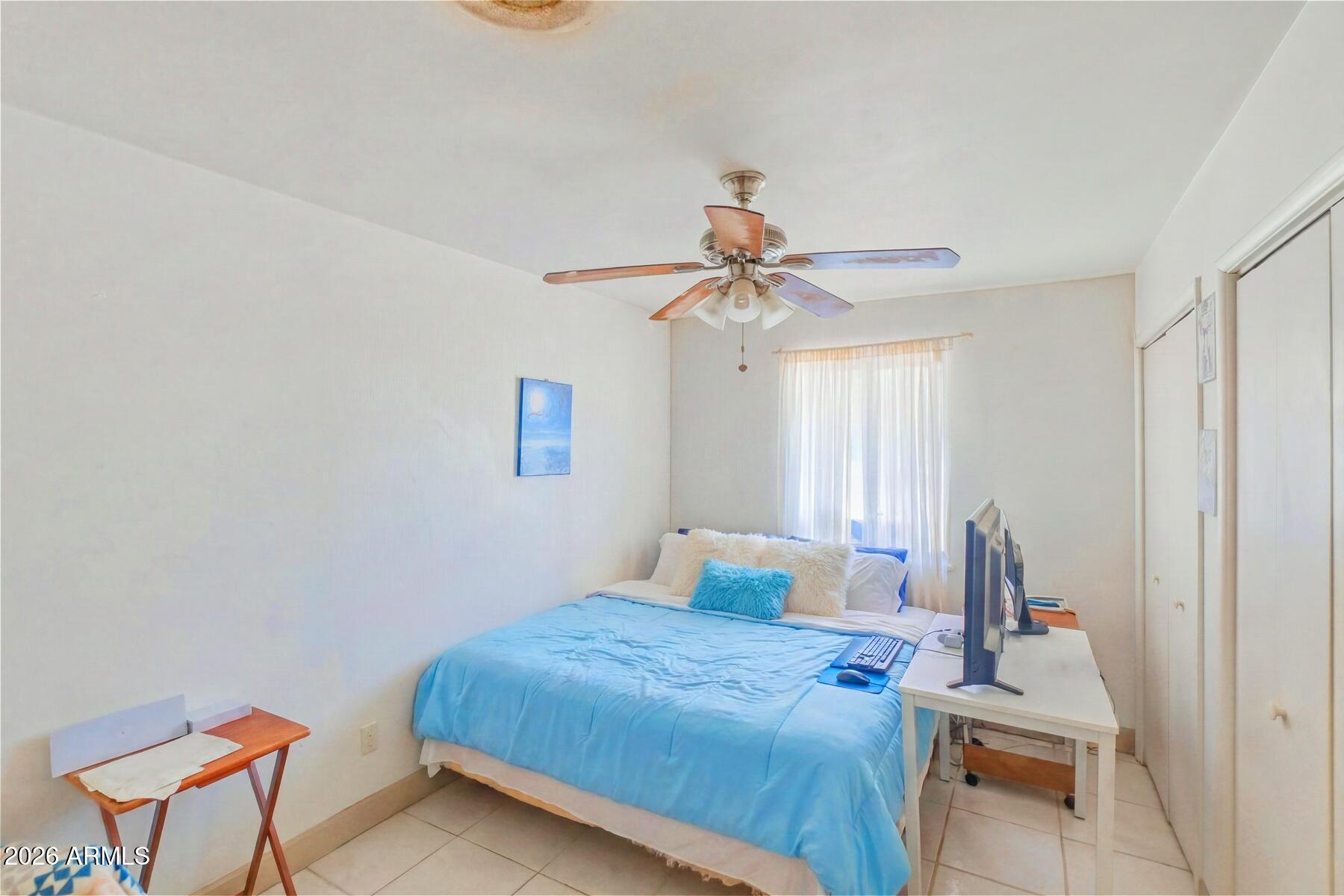 7027 North Bond Road McNeal, AZ 85617 - Photo 12 of 20 a bedroom with a bed and a chandelier