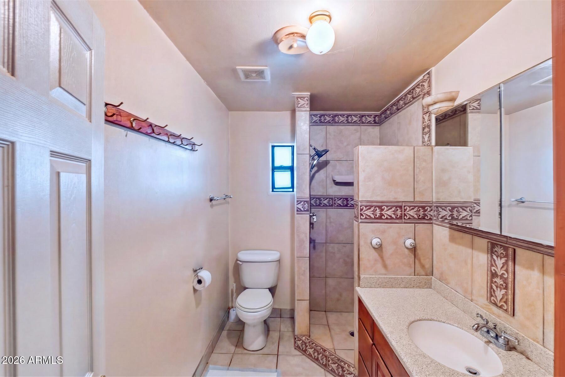7027 North Bond Road McNeal, AZ 85617 - Photo 13 of 20 a bathroom with a granite countertop sink toilet and shower