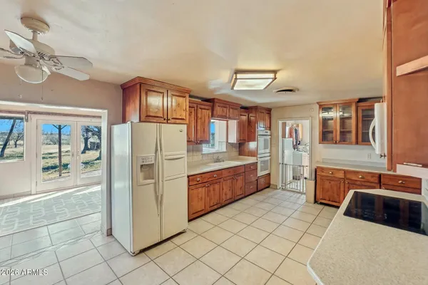 a kitchen with stainless steel appliances granite countertop a refrigerator and a stove top oven