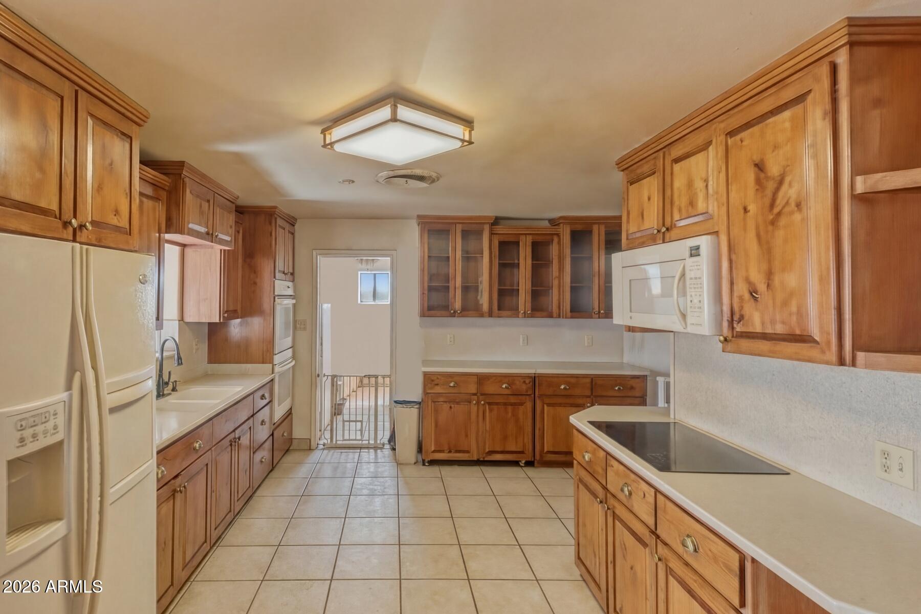 7027 North Bond Road McNeal, AZ 85617 - Photo 7 of 20 a kitchen with stainless steel appliances granite countertop a sink and cabinets
