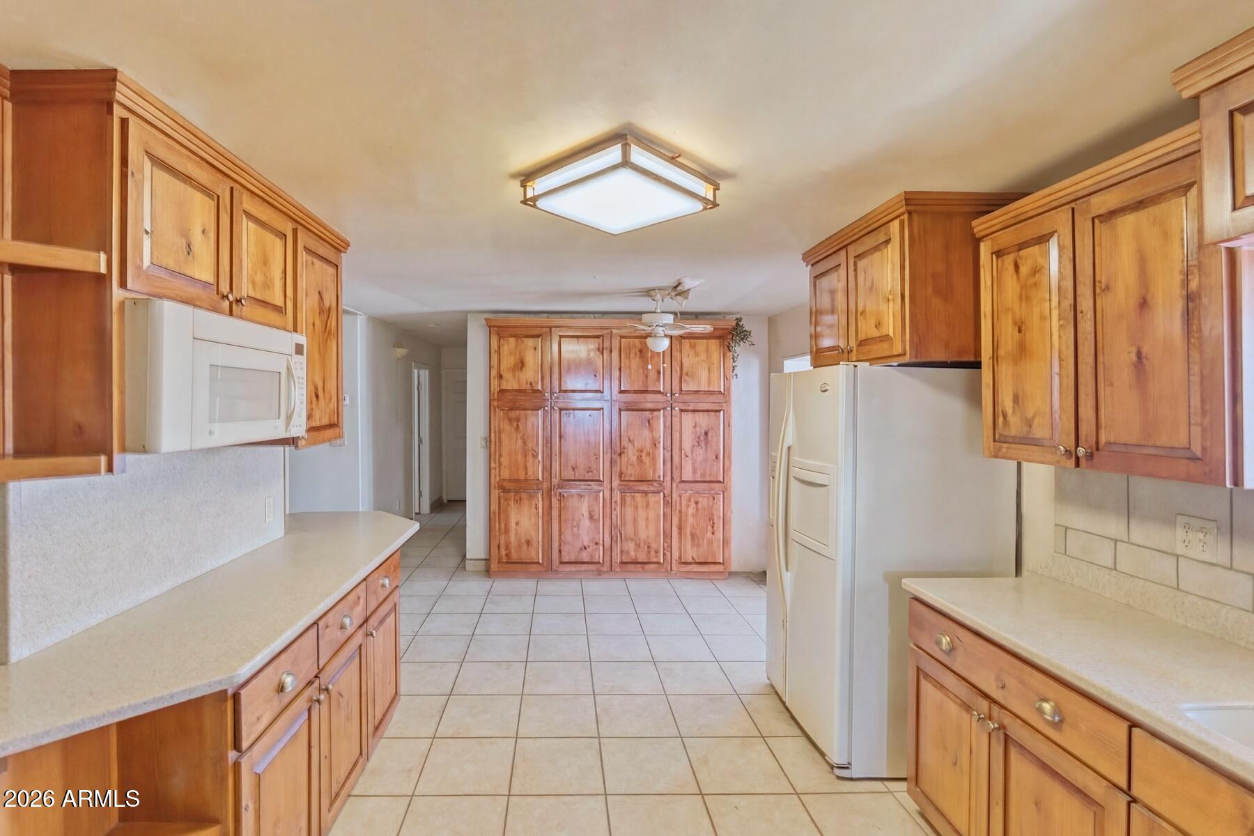 7027 North Bond Road McNeal, AZ 85617 - Photo 8 of 20 a kitchen with a refrigerator a sink and cabinets