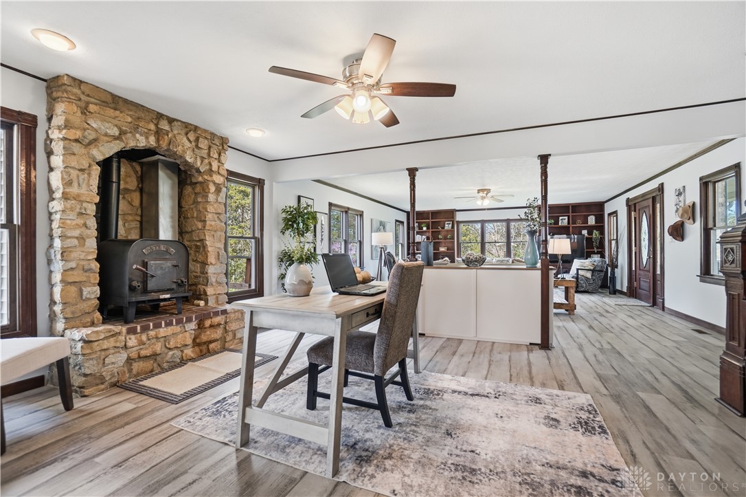 7553 Coffin Station Road Springfield, OH 45502 - Photo 38 of 95 This living space features warm wood flooring and a stone fireplace, creating an inviting atmosphere.