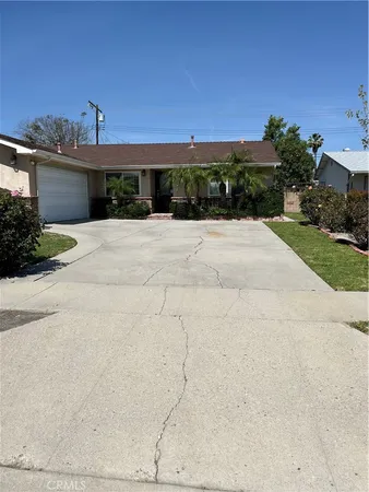 a front view of a house with a yard and a garage