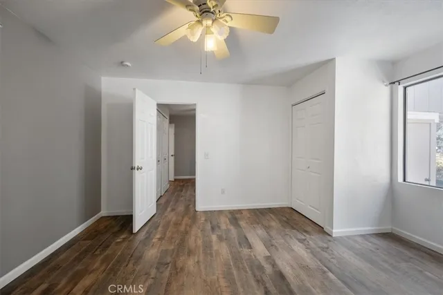 a view of a patio with table and chairs with wooden fence and plants