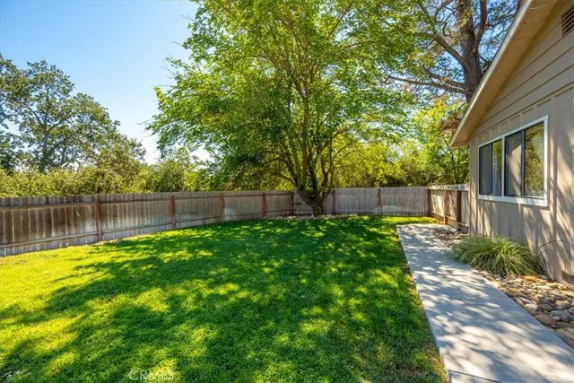 a view of a house with backyard and a patio