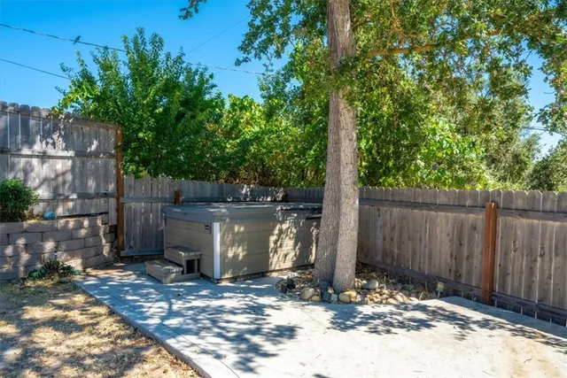 a view of a house with a wooden fence