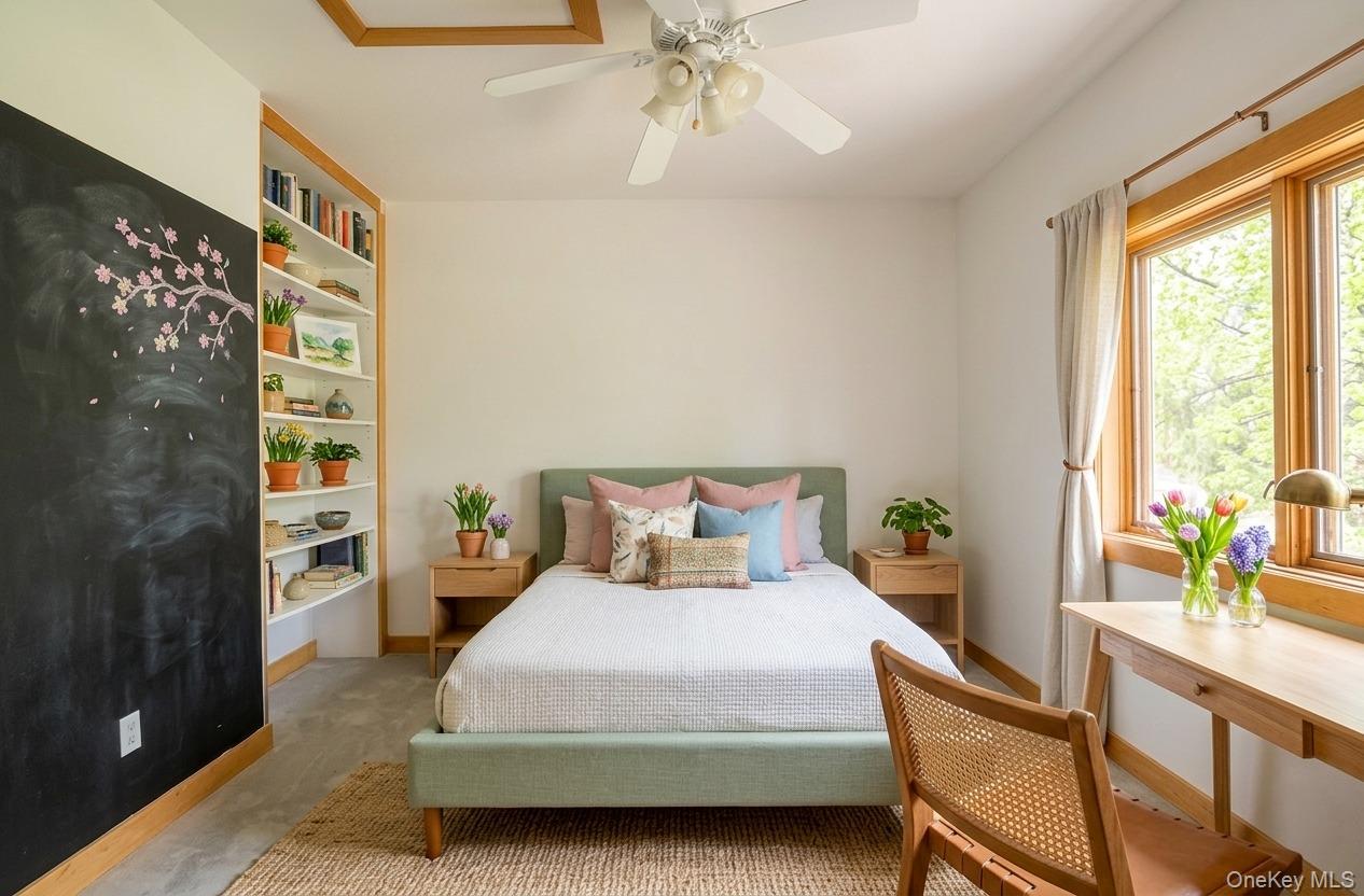 141 Oak Road Monroe, NY 10950 - Photo 5 of 6 a bedroom with a large bed and a chandelier
