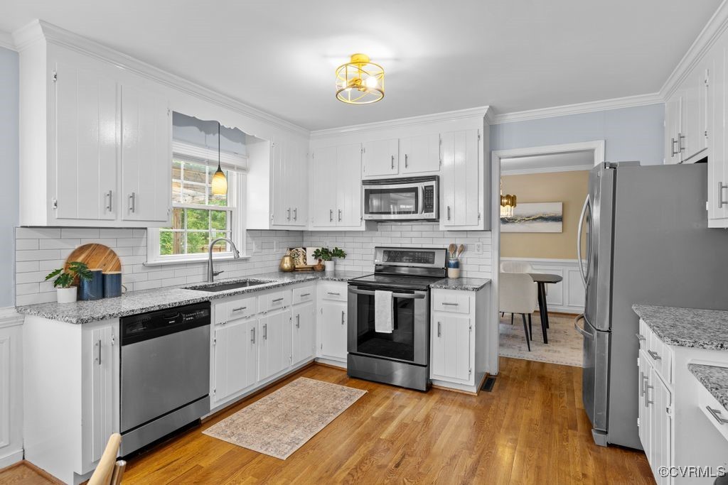 717 Shadowhill Court Midlothian, VA 23114 - Photo 11 of 44 a kitchen with granite countertop a sink cabinets stainless steel appliances and a window
