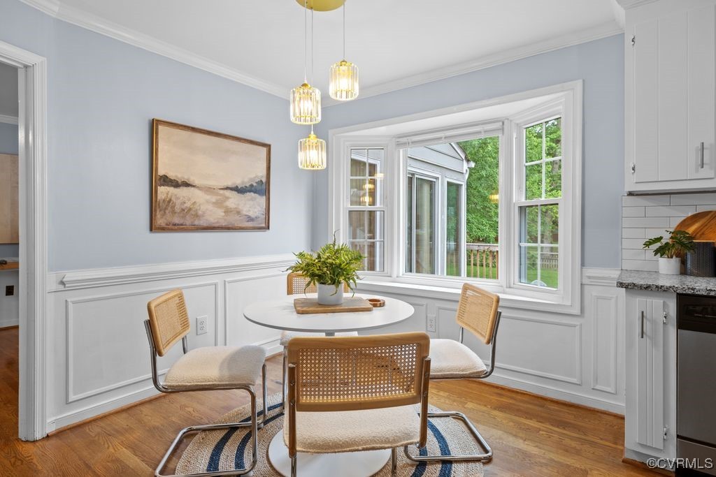 717 Shadowhill Court Midlothian, VA 23114 - Photo 12 of 44 a dining room with furniture a rug a potted plant and a chandelier