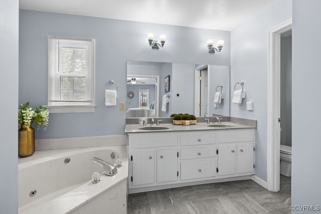 717 Shadowhill Court Midlothian, VA 23114 - Photo 20 of 44 a bathroom with a tub a sink double vanity granite and a bathtub
