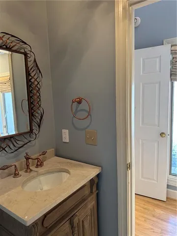 a bathroom with a sink vanity and a mirror