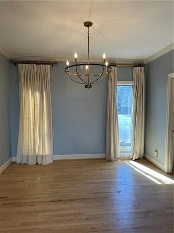a view of a room with wooden floor and window