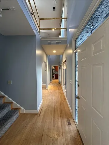 a view of a hallway with wooden floor