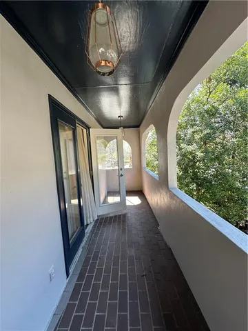 a view of balcony with wooden floor