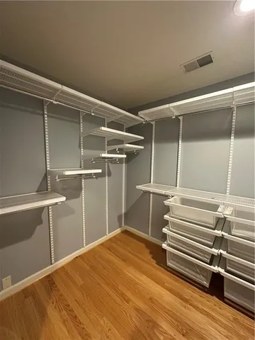 a view of room with stairs and wooden floor