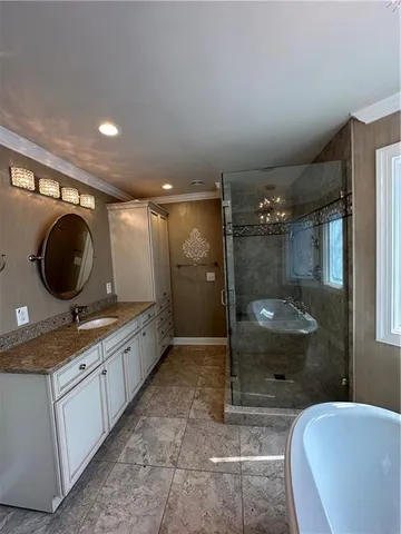 a bathroom with a sink a toilet a mirror and window