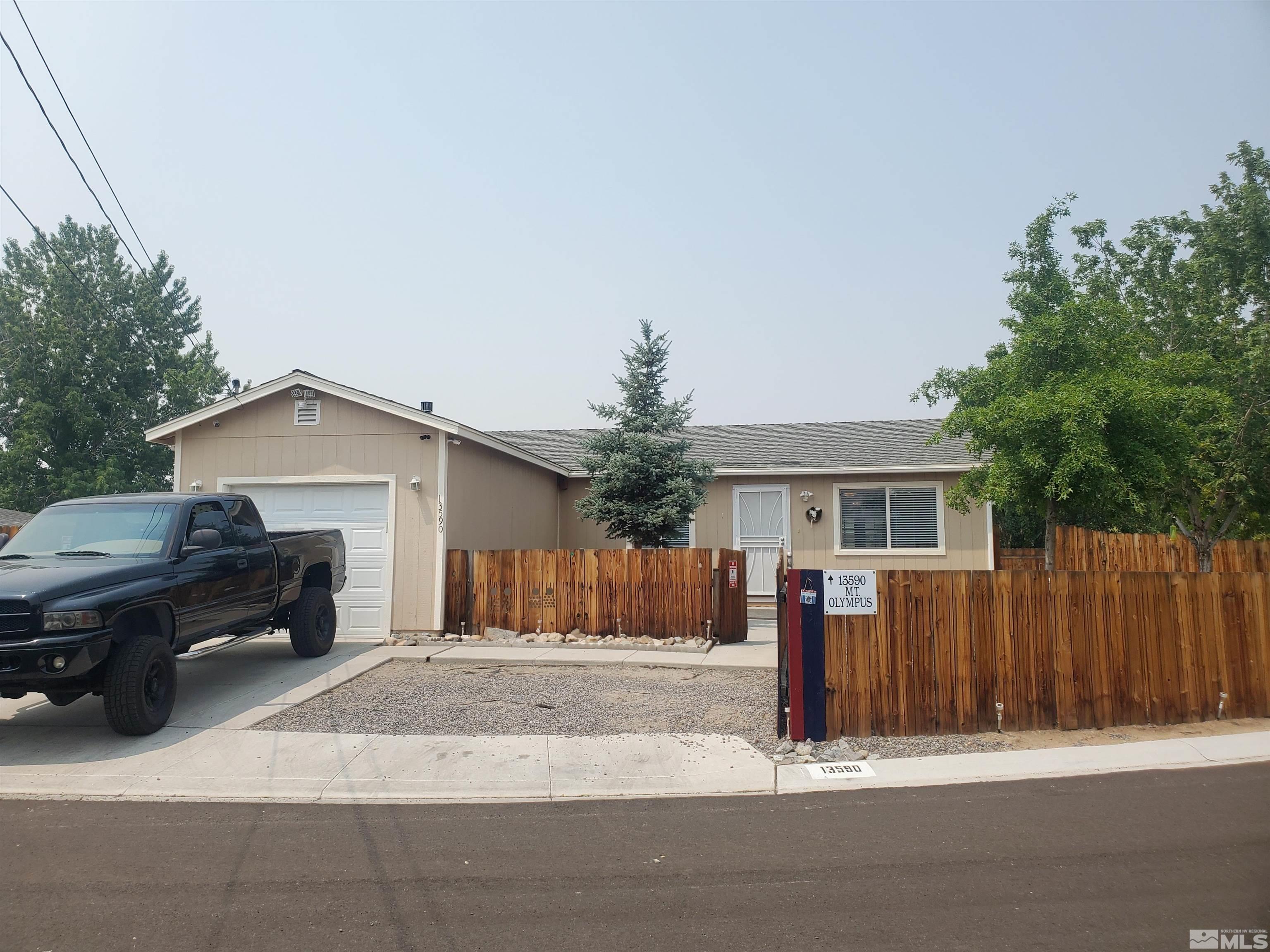 13590 Mt Olympus Street Reno, NV 89506 - Photo 1 of 17 a view of a house with a yard and large tree