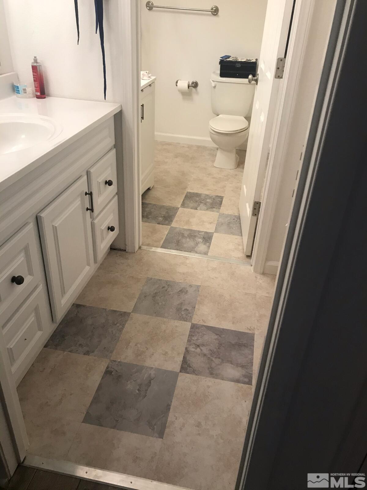 13590 Mt Olympus Street Reno, NV 89506 - Photo 11 of 17 a bathroom with a sink and mirror