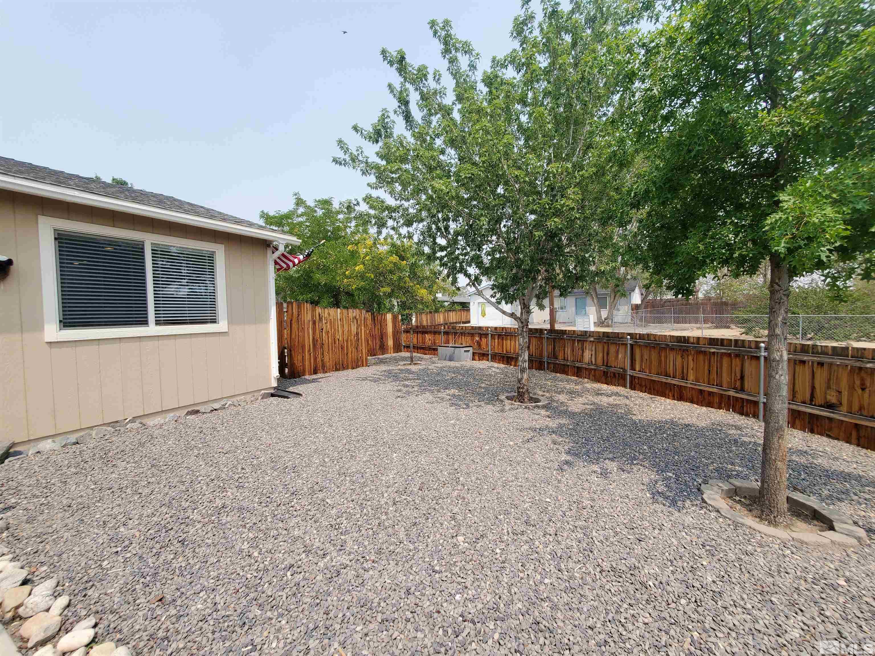 13590 Mt Olympus Street Reno, NV 89506 - Photo 16 of 17 a backyard of a house with lots of green space