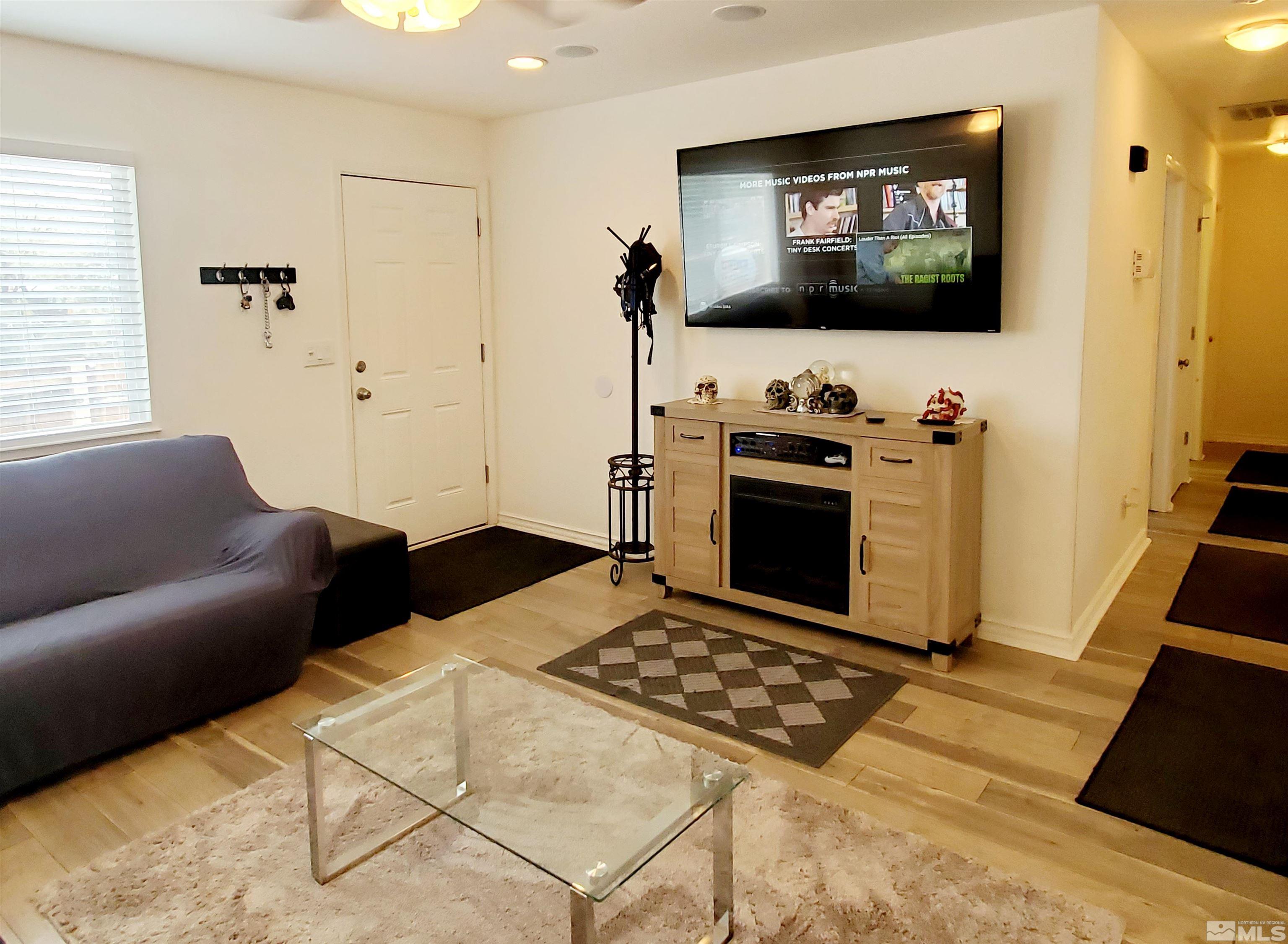 13590 Mt Olympus Street Reno, NV 89506 - Photo 4 of 17 a living room with furniture and a flat screen tv