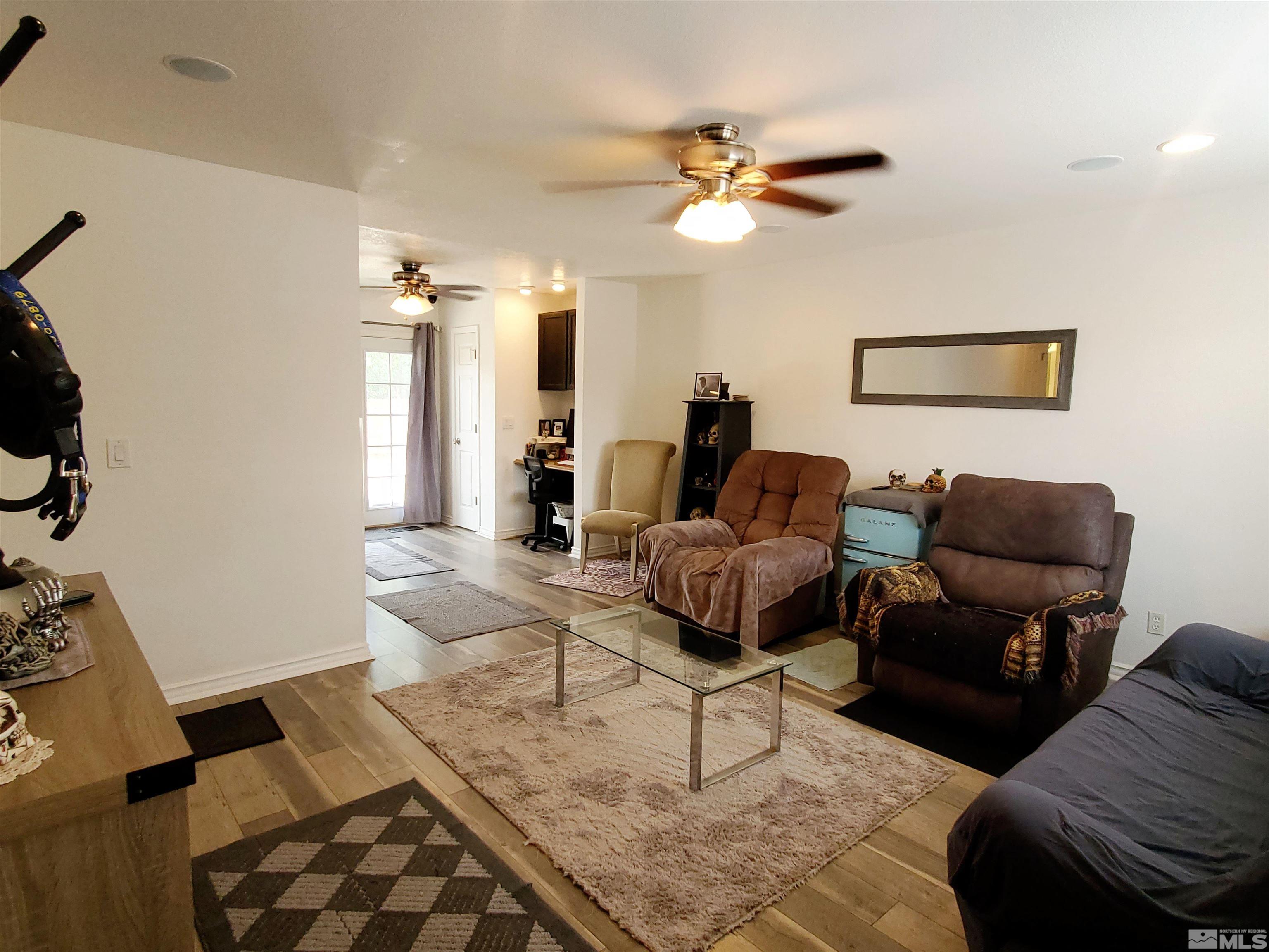 13590 Mt Olympus Street Reno, NV 89506 - Photo 5 of 17 a living room with furniture and a flat screen tv