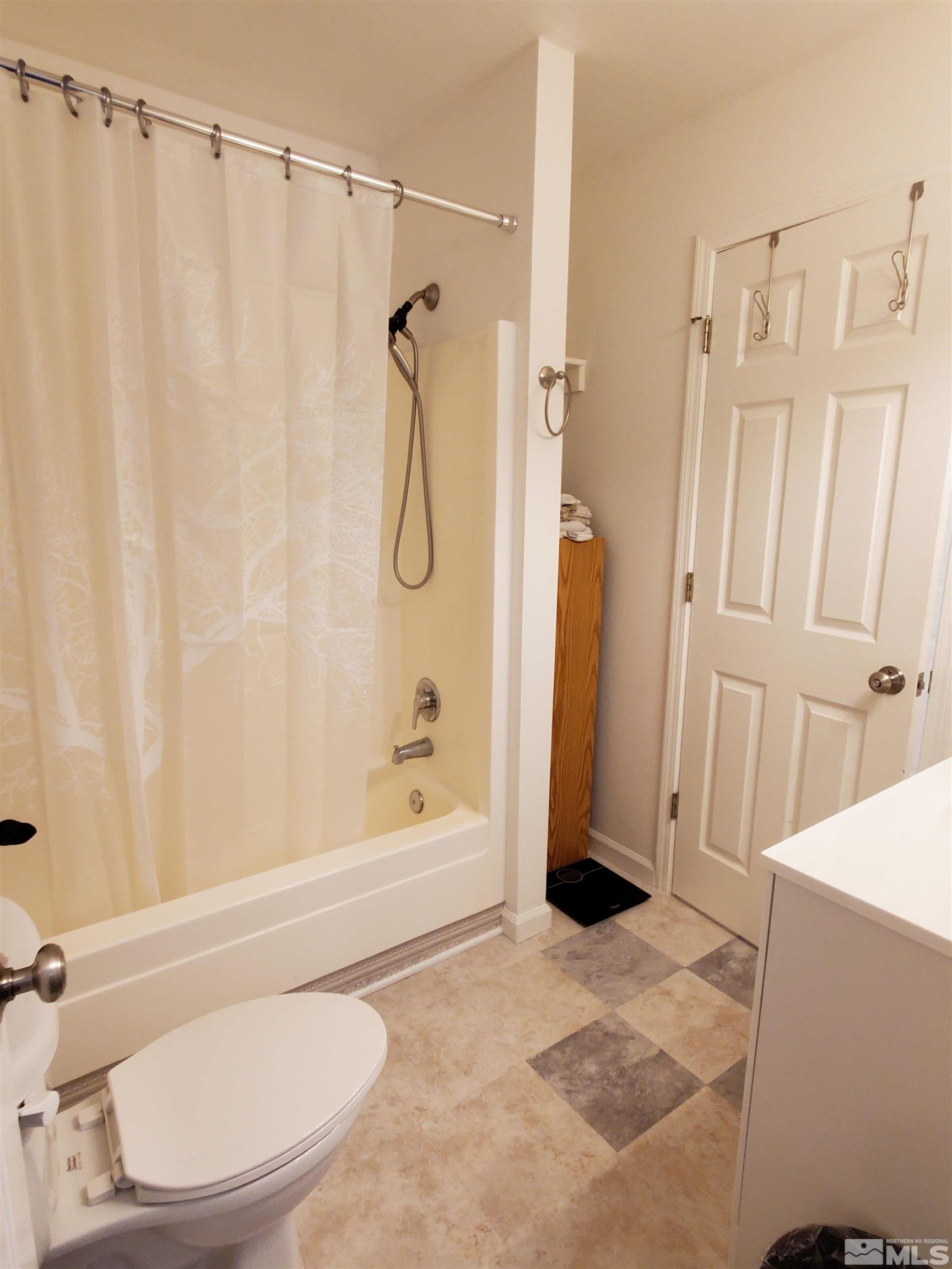 13590 Mt Olympus Street Reno, NV 89506 - Photo 9 of 17 a bathroom with a sink toilet and shower
