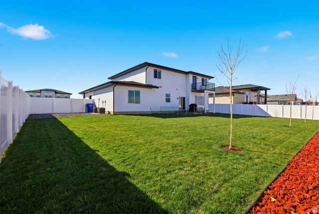 3902 West 825 North West Point, UT 84015 - Photo 46 of 49 Grass Virtually Added - Back of property featuring a fenced backyard, a patio, and a balcony