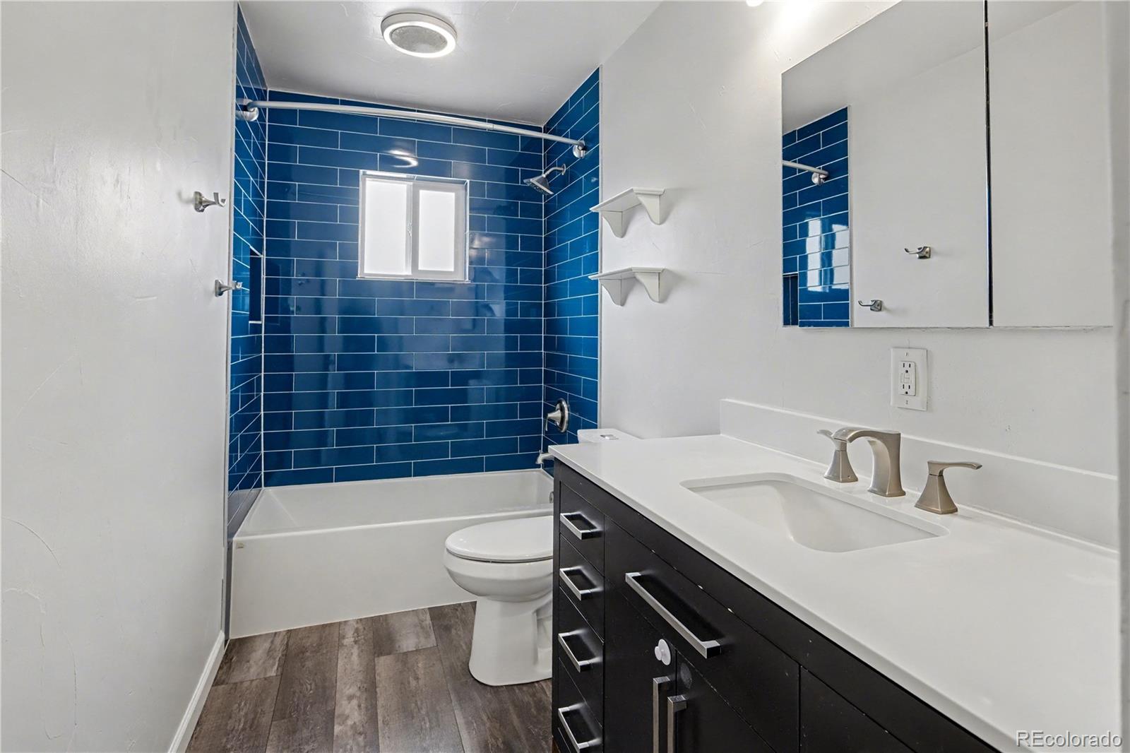 9142 Oberon Road Arvada, CO 80004 - Photo 13 of 35 a bathroom with a sink a toilet and shower