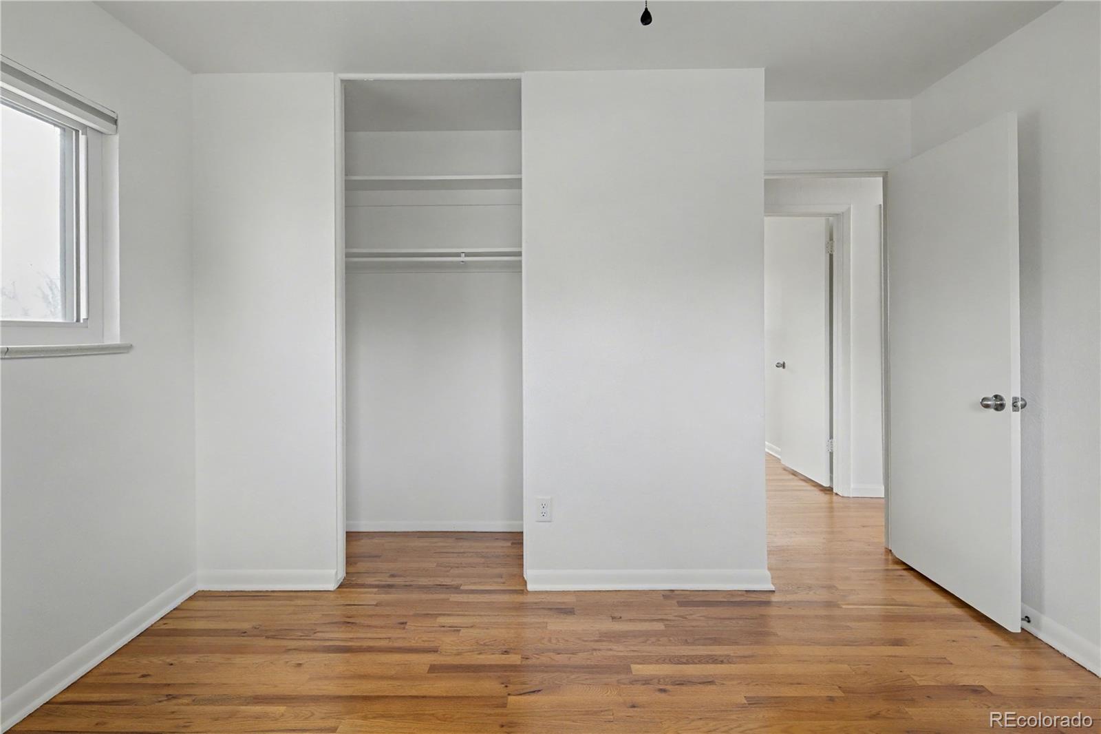 9142 Oberon Road Arvada, CO 80004 - Photo 15 of 35 a view of an empty room with wooden floor