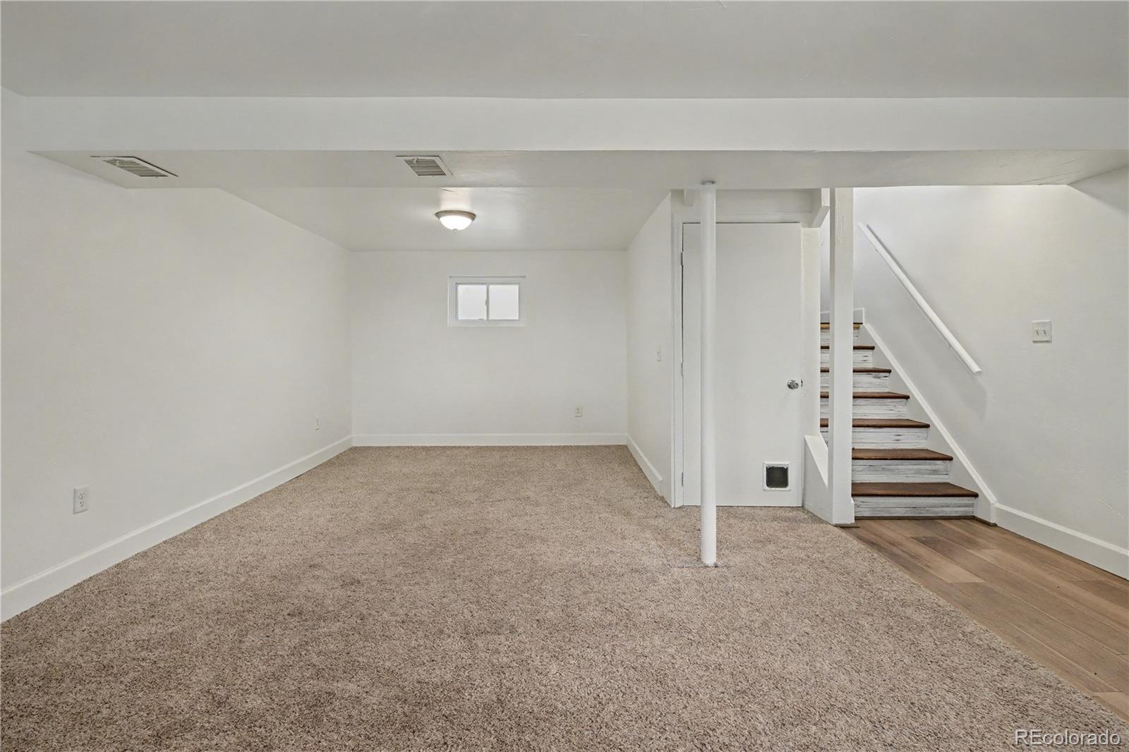 9142 Oberon Road Arvada, CO 80004 - Photo 18 of 35 a view of entryway and hall with wooden floor