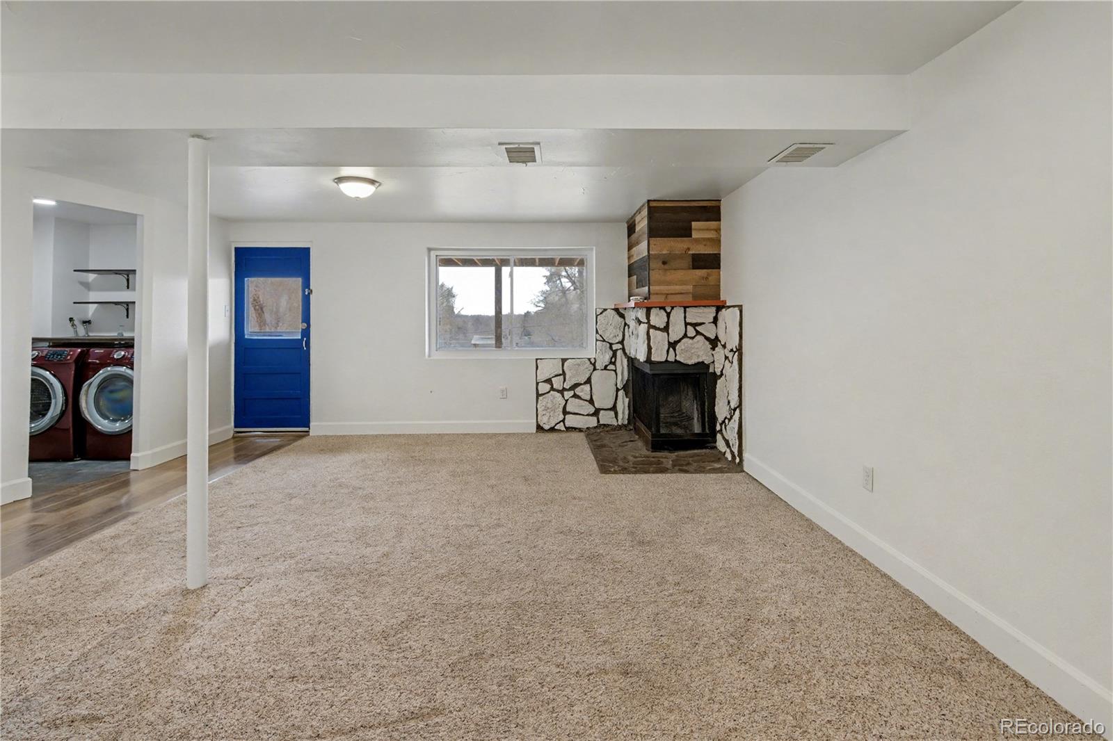 9142 Oberon Road Arvada, CO 80004 - Photo 20 of 35 an empty room with fireplace and windows