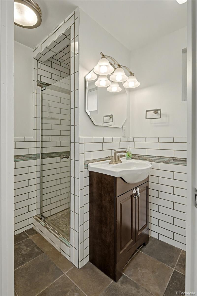 9142 Oberon Road Arvada, CO 80004 - Photo 22 of 35 a bathroom with a sink vanity and a mirror