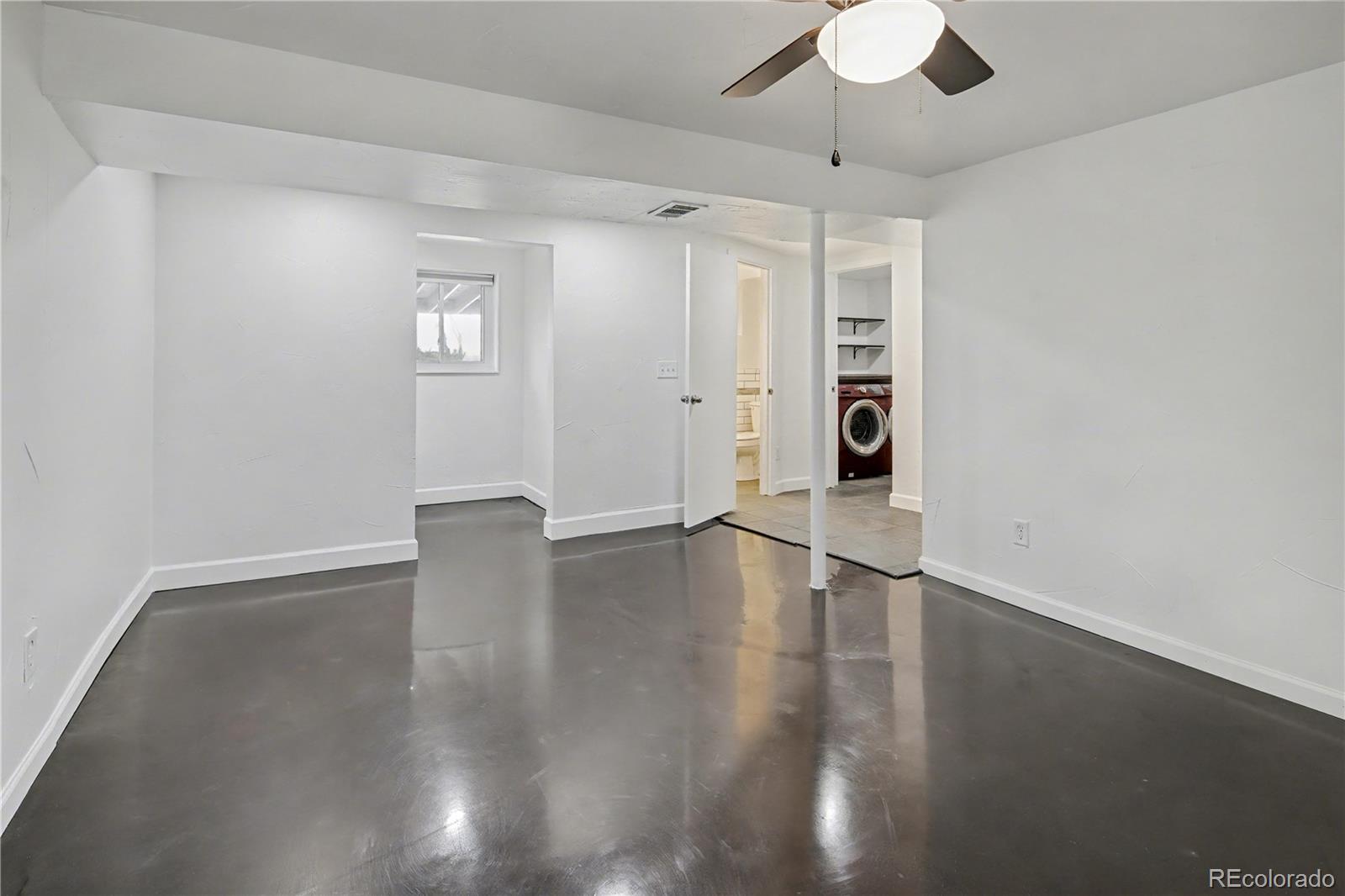 9142 Oberon Road Arvada, CO 80004 - Photo 24 of 35 a view of an empty room with wooden floor and a window