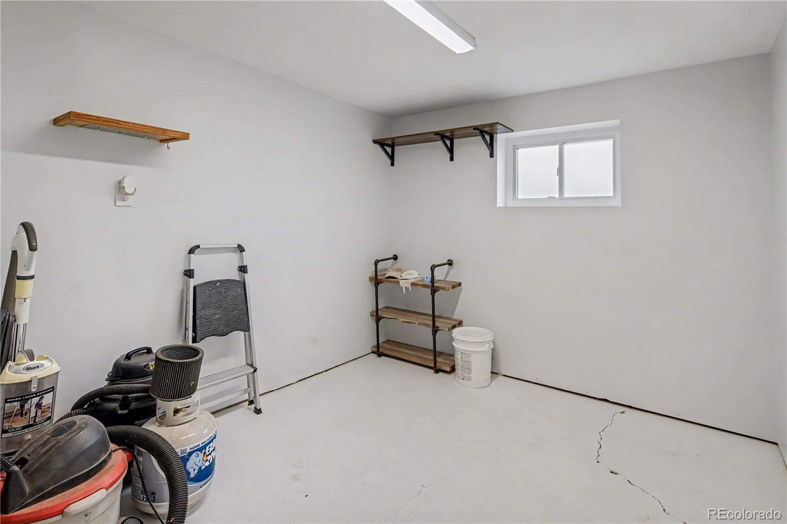 9142 Oberon Road Arvada, CO 80004 - Photo 26 of 35 a room with storage and utility